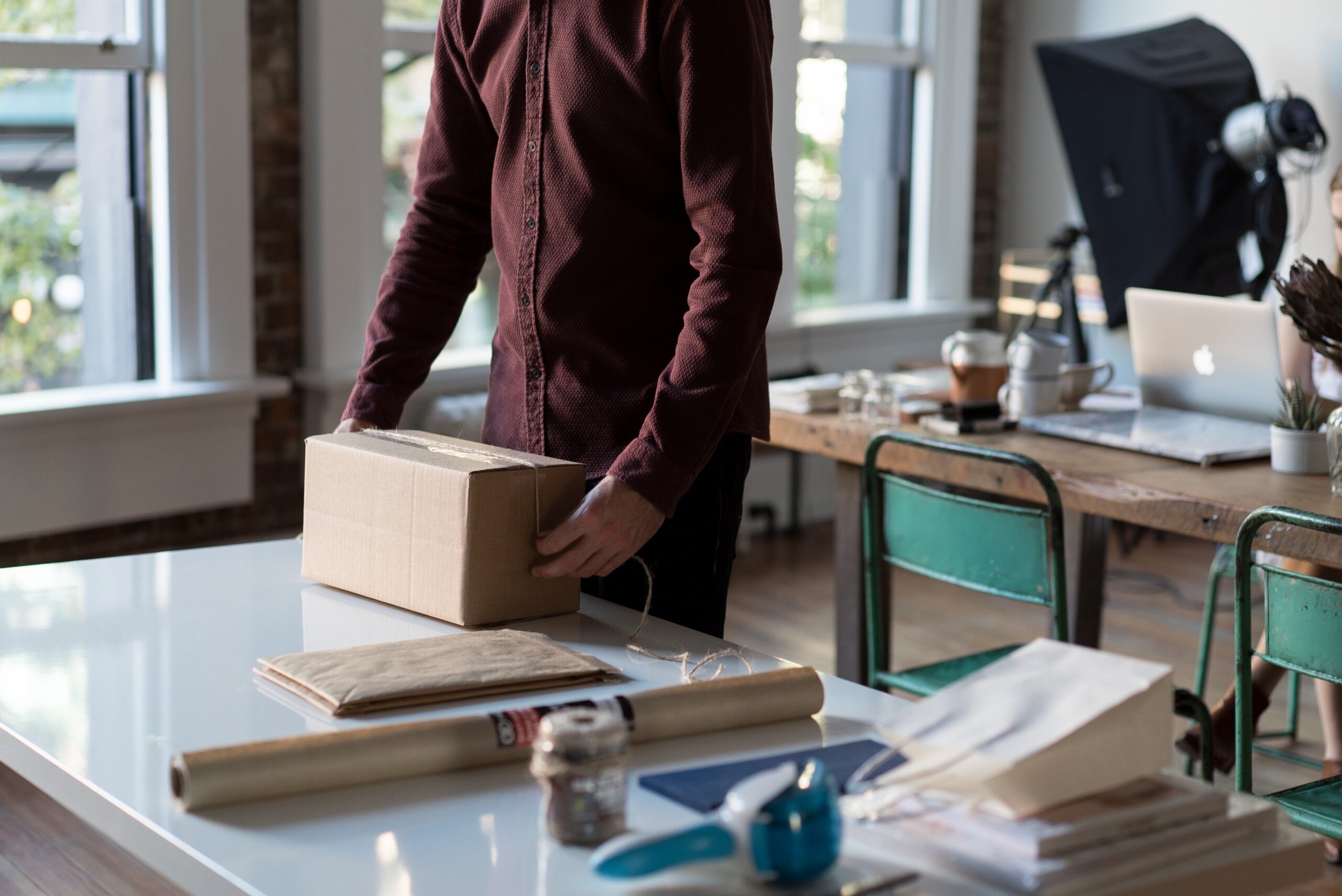 Man inspecting package. Represents packaging testing